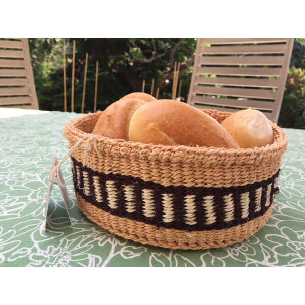 Wicker bread basket made of natural material with black and white pattern